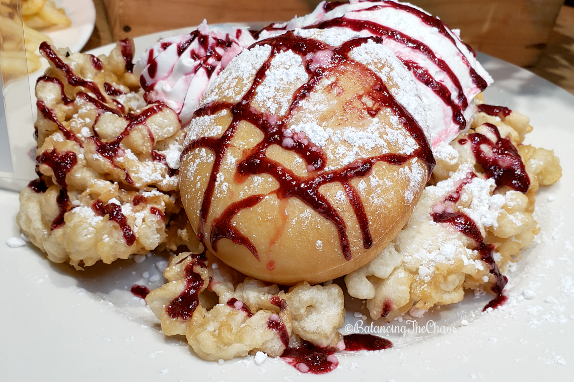 Funnel Cake topped with a Stuffed Donut, Boysenberry Ice Cream, and Boysenberry Whipped Cream - Log Ride Funnel Cake